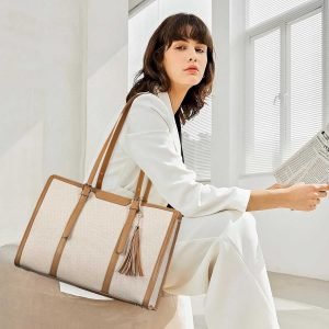 Woman wearing canvas leather tote bag in white suit